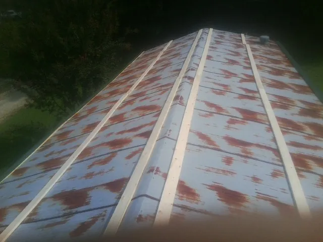 Rusted metal roof panels with new wood purlins before replacement — Storm Damage Roof Repair in Mckenna by Roofing Brothers