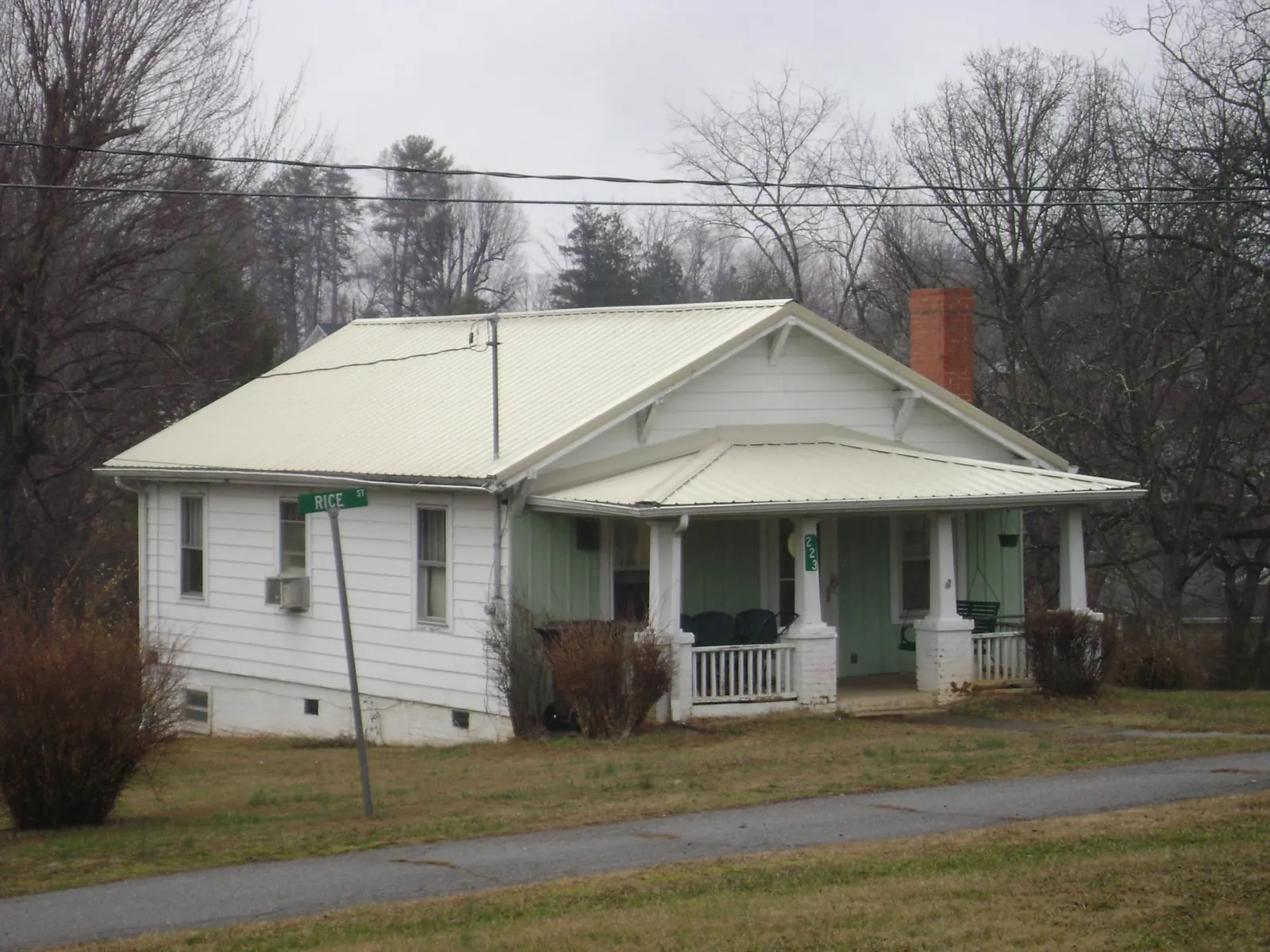 White metal roof on a craftsman bungalow at a street corner in Mckenna
